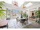 Sunroom dining area featuring skylights, ceiling fans and access to backyard patio with pool at 2805 High Sail Ct, Las Vegas, NV 89117