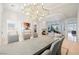 Spacious dining room with a modern chandelier, fireplace, and ample seating at 2805 High Sail Ct, Las Vegas, NV 89117