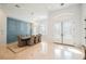 Elegant dining room with modern chandelier, detailed paneling and marble floors at 2805 High Sail Ct, Las Vegas, NV 89117