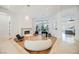 Spacious living room with grand piano, fireplace, and large windows at 2805 High Sail Ct, Las Vegas, NV 89117