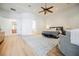 Main bedroom featuring hardwood floors, ceiling fan, sitting area, Primary bath access, and plenty of natural light at 2805 High Sail Ct, Las Vegas, NV 89117