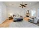 Main bedroom featuring hardwood floors, ceiling fan, fireplace, sitting area and plenty of natural light at 2805 High Sail Ct, Las Vegas, NV 89117