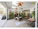 Enclosed patio with ceiling fans, skylights, dining table and chairs, and lush plants for a relaxing outdoor dining experience at 2805 High Sail Ct, Las Vegas, NV 89117