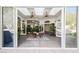 Indoor/outdoor living space with dining table and chairs, ceiling fans, and sliding glass doors leading to the pool area at 2805 High Sail Ct, Las Vegas, NV 89117