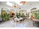 Enclosed patio with skylights and ceiling fans features a dining table and chairs surrounded by lush plants at 2805 High Sail Ct, Las Vegas, NV 89117