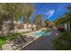 Inviting backyard pool and spa area with mature landscaping and lounge chairs at 2805 High Sail Ct, Las Vegas, NV 89117