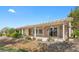 Relaxing covered patio with stone pillars and a water feature, perfect for outdoor living at 2864 Sumter Valley Cir, Henderson, NV 89052
