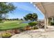 Stunning backyard view of a golf course and pond, framed by a covered patio and water feature at 2864 Sumter Valley Cir, Henderson, NV 89052