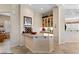 Stylish bar area with sleek countertops, decorative glass cabinets, and views into the living space at 2864 Sumter Valley Cir, Henderson, NV 89052