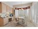 Cozy breakfast nook with bright windows, custom window treatment, and a custom desk at 2864 Sumter Valley Cir, Henderson, NV 89052