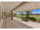Relaxing covered patio with stone columns, a built-in grill, and a scenic view of the golf course at 2864 Sumter Valley Cir, Henderson, NV 89052