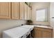 Bright laundry room features modern appliances, built-in storage, and a utility sink at 2864 Sumter Valley Cir, Henderson, NV 89052
