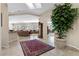 Open-concept living space featuring tile floors, skylights, and comfortable seating arrangements at 2864 Sumter Valley Cir, Henderson, NV 89052