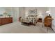 This spacious main bedroom features large windows, carpeted floors, vintage furnishings, and decor at 2864 Sumter Valley Cir, Henderson, NV 89052
