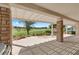 Covered patio with stone columns offering views of the golf course and fountain feature at 2864 Sumter Valley Cir, Henderson, NV 89052