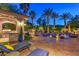 A luxurious outdoor living space with a pool, BBQ area, and lush landscaping is great for entertaining at 3051 Traverse Creek Ln, Las Vegas, NV 89135