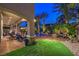 Luxurious backyard with a pool, fire pit, and manicured landscaping at 3051 Traverse Creek Ln, Las Vegas, NV 89135