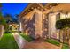 Exterior view showcasing a backyard with a dog run/exit, outdoor kitchen, and well-manicured landscaping at 3051 Traverse Creek Ln, Las Vegas, NV 89135