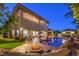 Stunning backyard featuring a pool, fire pit, and comfortable seating area, perfect for entertaining at 3051 Traverse Creek Ln, Las Vegas, NV 89135
