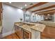 Entertainers bar featuring granite countertops, stainless steel appliances, and seating area at 3051 Traverse Creek Ln, Las Vegas, NV 89135
