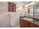 Stylish bathroom featuring a vanity with granite countertops and unique light fixture at 3051 Traverse Creek Ln, Las Vegas, NV 89135