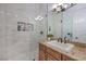 Bright bathroom featuring tiled shower, vanity with granite countertop, and modern fixtures at 3051 Traverse Creek Ln, Las Vegas, NV 89135