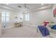 Spacious bedroom with two large windows, and a desk with gold trim at 3051 Traverse Creek Ln, Las Vegas, NV 89135