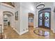 An elegant foyer with decorative doors, a chandelier, and tile flooring welcomes you home at 3051 Traverse Creek Ln, Las Vegas, NV 89135
