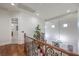 Upstairs hallway with wood floors, iron railing, and views of the foyer below at 3051 Traverse Creek Ln, Las Vegas, NV 89135