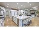 Open concept kitchen with a large island and seating, flowing to the living room at 3051 Traverse Creek Ln, Las Vegas, NV 89135