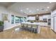 Gourmet kitchen features a large island with seating, custom cabinetry, and natural light at 3051 Traverse Creek Ln, Las Vegas, NV 89135
