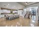Gourmet kitchen with a large island, counter seating, and seamless flow to the staircase at 3051 Traverse Creek Ln, Las Vegas, NV 89135