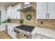 Modern kitchen featuring stainless steel appliances, custom cabinets, and stone backsplash at 3051 Traverse Creek Ln, Las Vegas, NV 89135