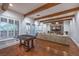 Spacious living room with hardwood floors, exposed wood beams, and a fireplace at 3051 Traverse Creek Ln, Las Vegas, NV 89135