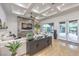 Open living room with coffered ceilings, stone fireplace, and sliding glass doors to outdoor patio at 3051 Traverse Creek Ln, Las Vegas, NV 89135