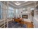 The bright office has built-in shelves, a fireplace, wood floors, and plantation shutters at 3051 Traverse Creek Ln, Las Vegas, NV 89135