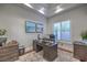 Well-lit home office featuring large window, tray ceiling, and a desk with storage at 3051 Traverse Creek Ln, Las Vegas, NV 89135