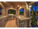 Outdoor kitchen with stone accents, a built-in grill, and ample counter space for food preparation at 3051 Traverse Creek Ln, Las Vegas, NV 89135