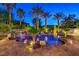 A private backyard oasis with rock waterfall, palm trees, and a freeform pool awaits at 3051 Traverse Creek Ln, Las Vegas, NV 89135