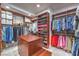Walk-in closet featuring custom storage, wood cabinetry, and ample hanging space at 3051 Traverse Creek Ln, Las Vegas, NV 89135