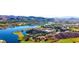 Breathtaking aerial view of a lakeside resort, golf course and mountains in the distance at 32 Via Vasari # 103, Henderson, NV 89011