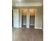 Carpeted bedroom with two closet doors and neutral paint at 32 Via Vasari # 103, Henderson, NV 89011
