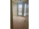 Bright, carpeted bedroom with tray ceiling, large windows and neutral paint at 32 Via Vasari # 103, Henderson, NV 89011