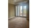 Large, carpeted bedroom with sliding doors to balcony and neutral paint at 32 Via Vasari # 103, Henderson, NV 89011