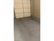 Spacious garage with a roll-up door and a stained concrete floor at 32 Via Vasari # 103, Henderson, NV 89011