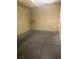 Spacious garage with a white door and a stained concrete floor at 32 Via Vasari # 103, Henderson, NV 89011