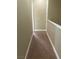 Carpeted hallway with neutral paint and white trim leads to other rooms at 32 Via Vasari # 103, Henderson, NV 89011