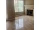 Cozy living room with beautiful tile flooring, a fireplace, and plenty of natural light at 32 Via Vasari # 103, Henderson, NV 89011