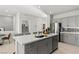 Bright kitchen featuring gray cabinets, a center island with seating, and stainless steel appliances at 321 Cymbal Pl # Lot 130, Henderson, NV 89015