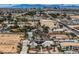 Aerial view of a home with a desert landscape, a lush green yard, solar panels and the city skyline in the distance at 3290 Vicki Ave, Las Vegas, NV 89139